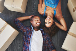 Couple laying on the floor with boxes