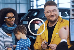 Family talking with car dealership representative