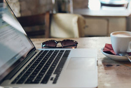 laptop, coffee, and sunglasses